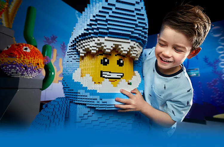 boy with lego figure dressed as shark